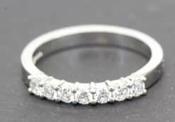 Diamond eternity ring with multiple sparkling stones.