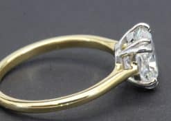 Engagement ring with a sparkling diamond in a gold setting.