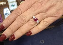 Ruby and diamond engagement ring on a woman's hand.