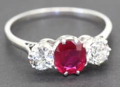 Stunning ruby and diamond ring with a central red gemstone and sparkling side stones.