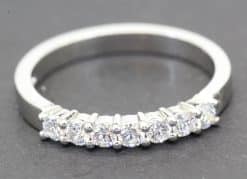 Diamond eternity ring with sparkling stones on a silver band.