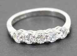 Diamond ring with multiple sparkling stones on a silver band.