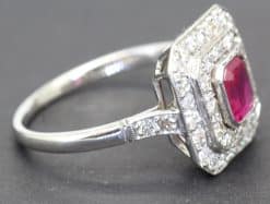 Elegant ruby and diamond ring with a silver band, perfect for special occasions.