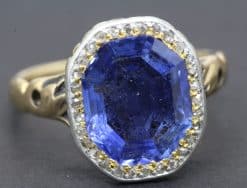 Blue sapphire gemstone ring with diamond accents.
