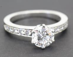 Elegant diamond engagement ring with a large central stone and pavé band, crafted by Weldons Jewelle.