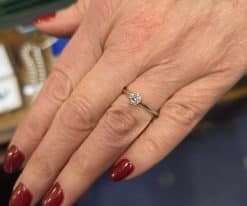 Close-up of a diamond engagement ring on a woman's finger.