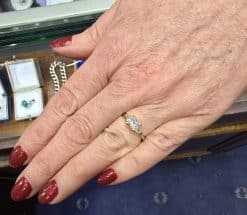 Engagement ring with a sparkling diamond on a woman's hand.