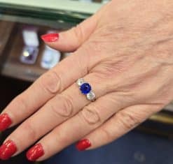 Elegant sapphire and diamond ring on a woman's finger.