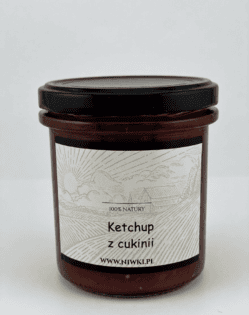 Jar of zucchini ketchup with a black lid, label shows 'Ketchup z cukinii' and the website www.niwki.pl with a rural illustration in the background.