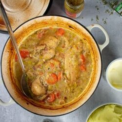 Cider and Chicken casserole in cast iron cooking dish, mustard, tarragon, mash surrounding