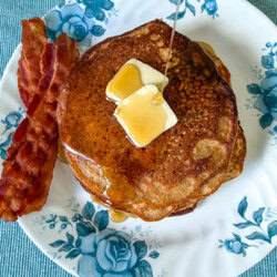 Einkorn flour pancake with maple syrup being drizzled over it