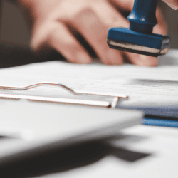 Image of documents being stamped for Immigration act header image