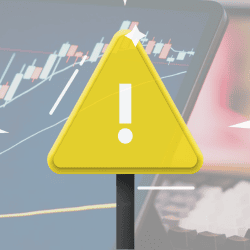 Image of a warning sign over a tech and finance background image.