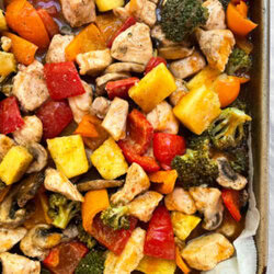 top shot of chicken and vegetables on a baking sheet
