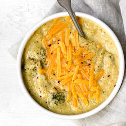 top shot of cheddar broccoli soup made in the instant pot topped with cheese