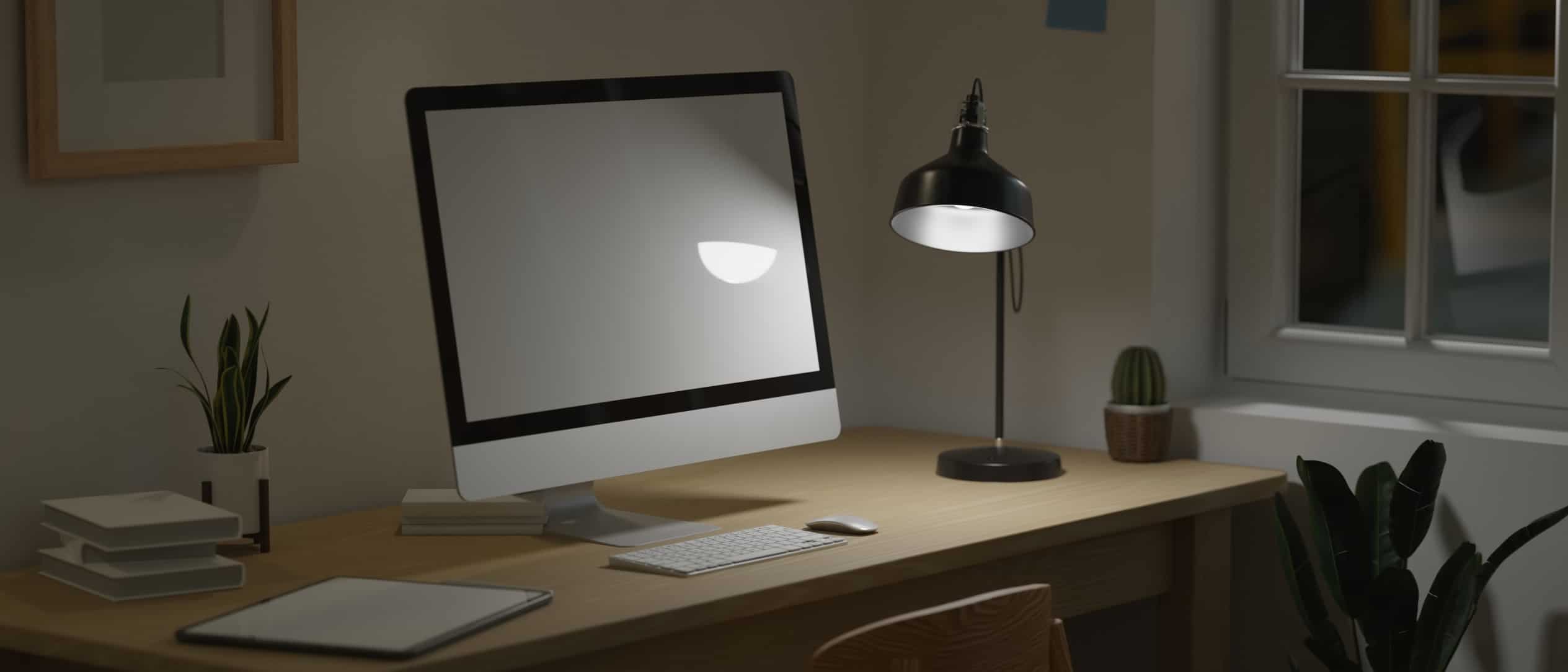 home-office-at-midnight-concept-blank-computer-monitor-under-low-light-from-lamp-decor-with-modern_