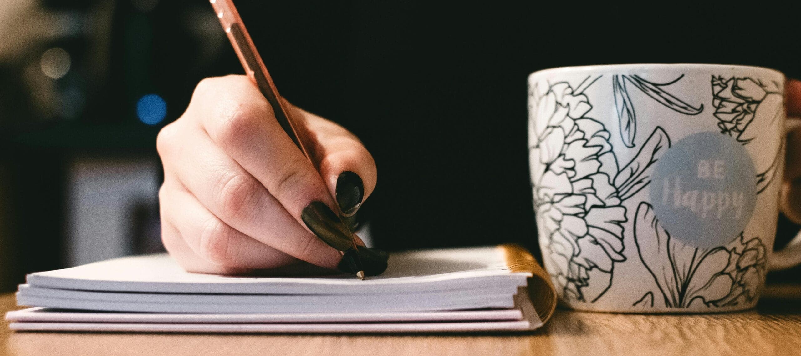 Woman writing black nailpolish