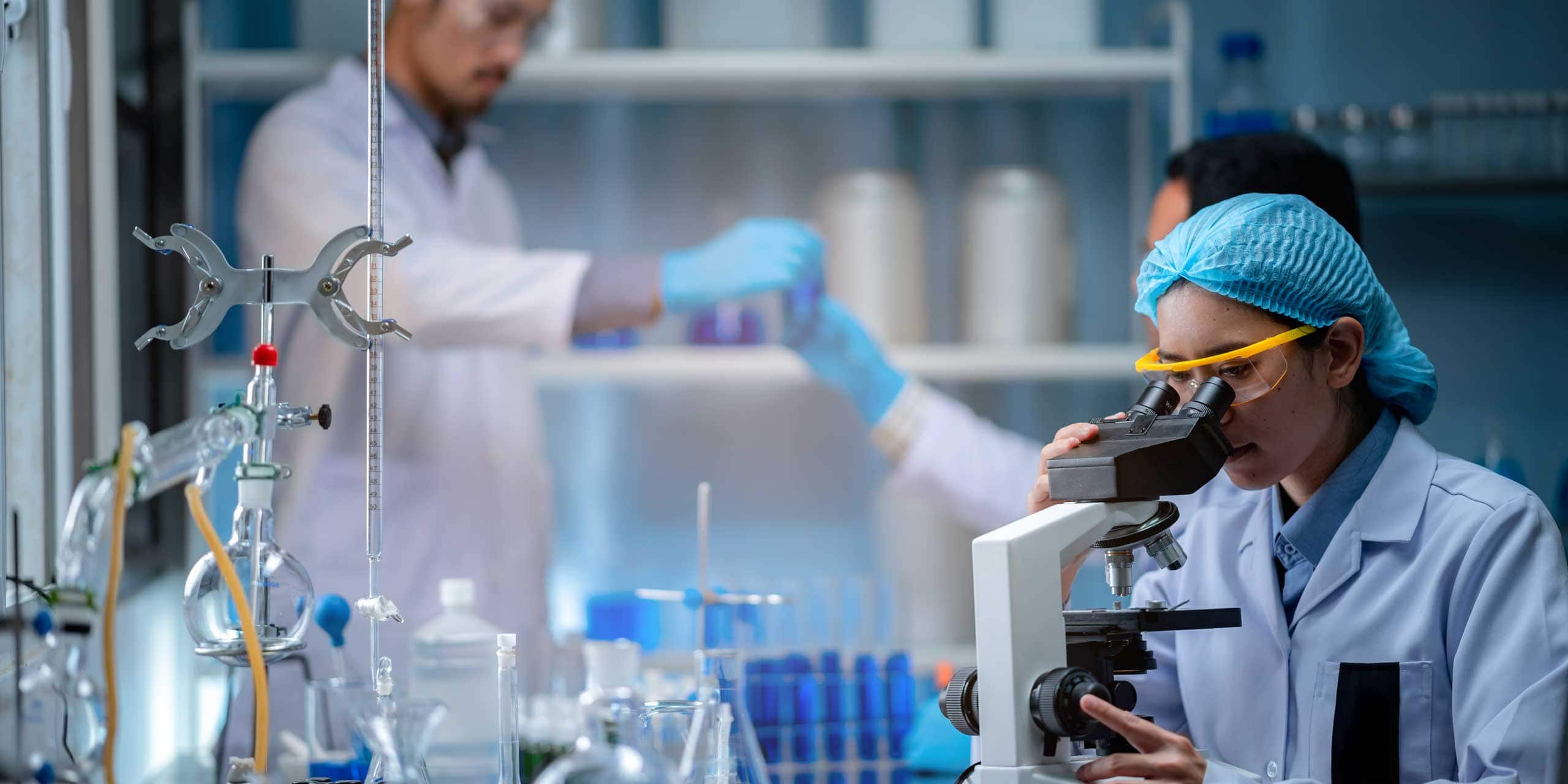 laboratory technician working with scientific equipment during a pharmaceutical research process