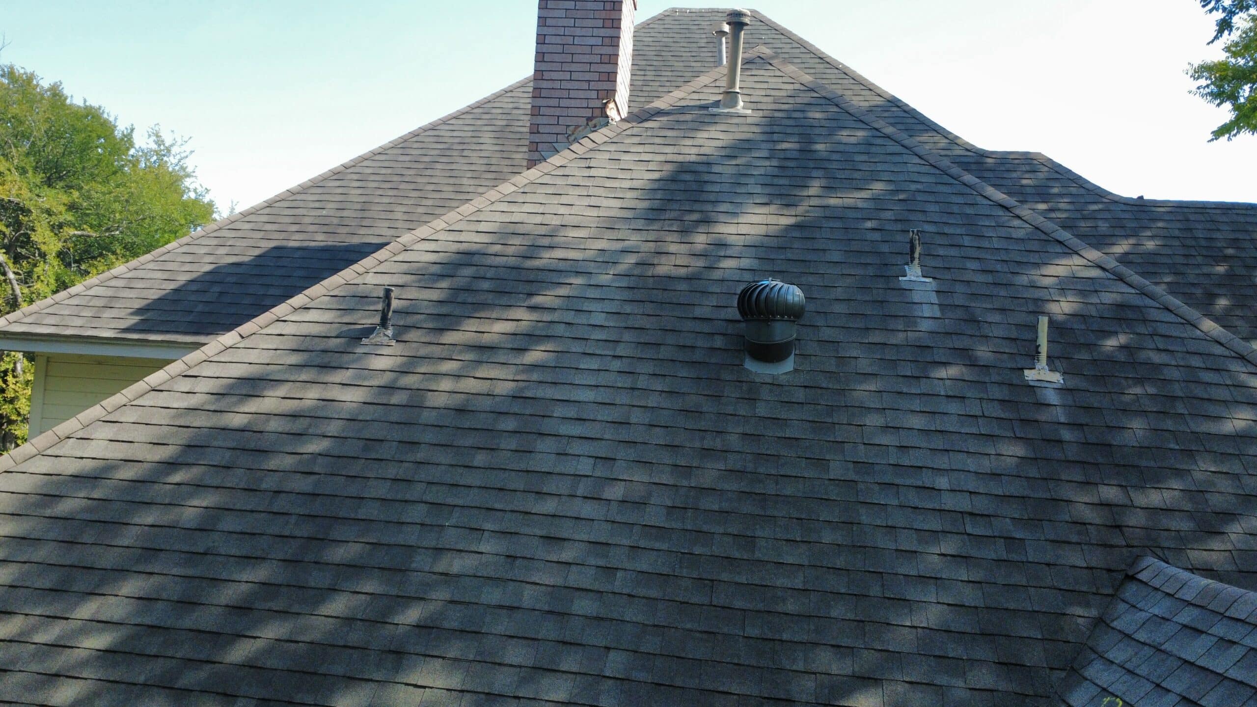 Drone view looking down on a hip roof in Dallas-Fort Worth, the aerial documentation used to support a storm damage insurance claim