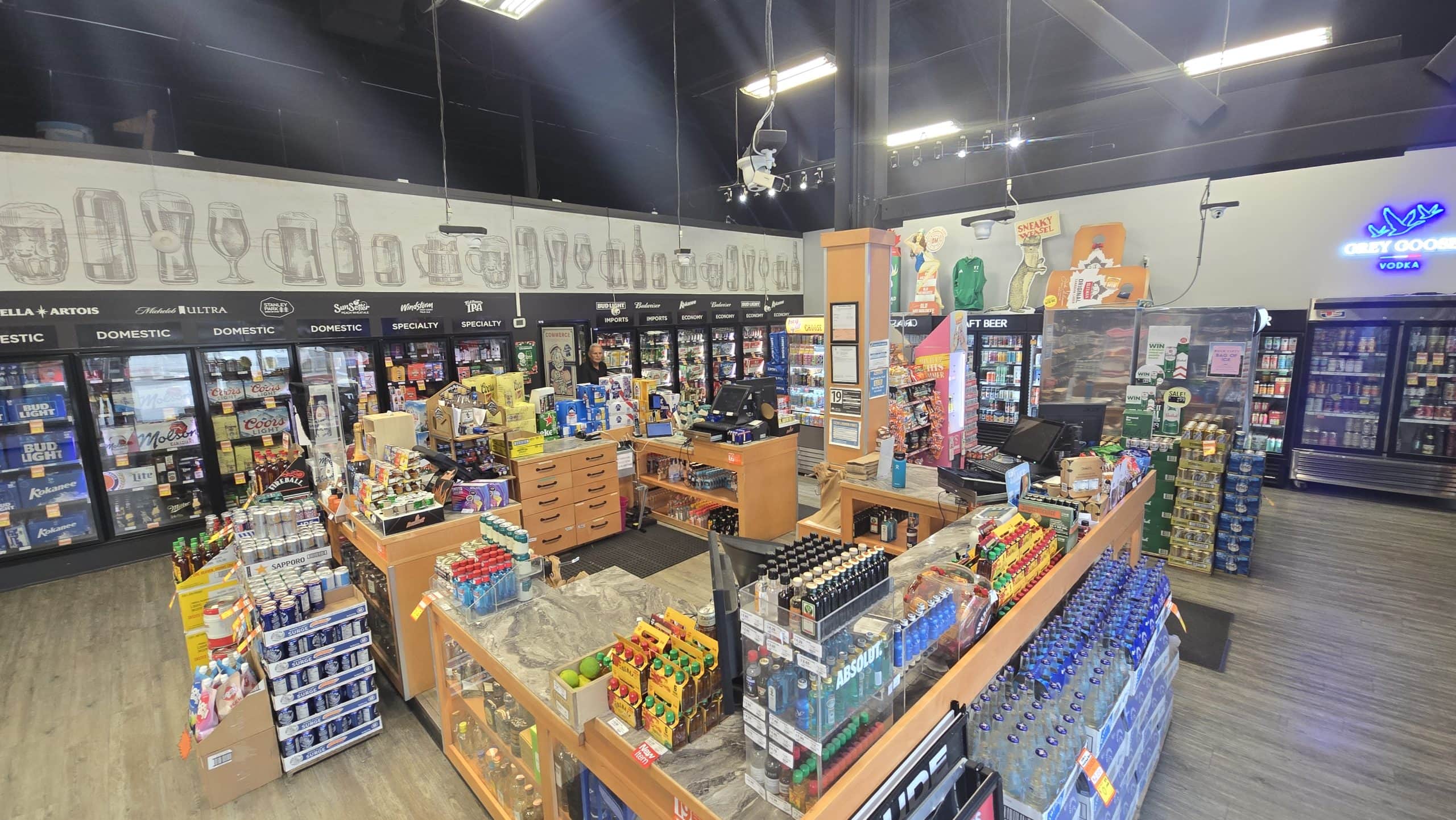Interior of a licensed retail liquor store for sale in the Central Okanagan, BC — cooler wall and retail floor