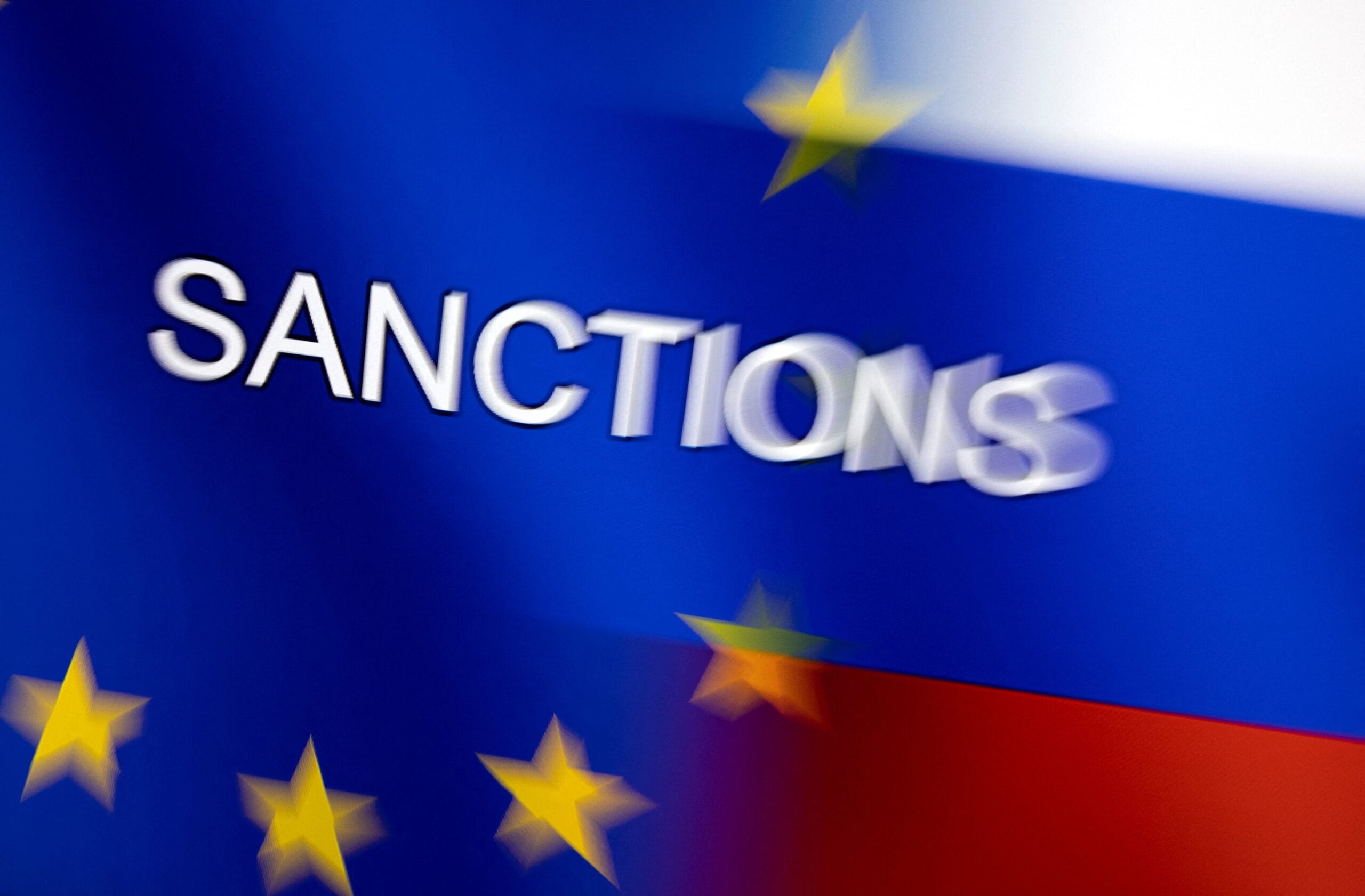illustration shows word "sanctions" displayed on eu and russian flags