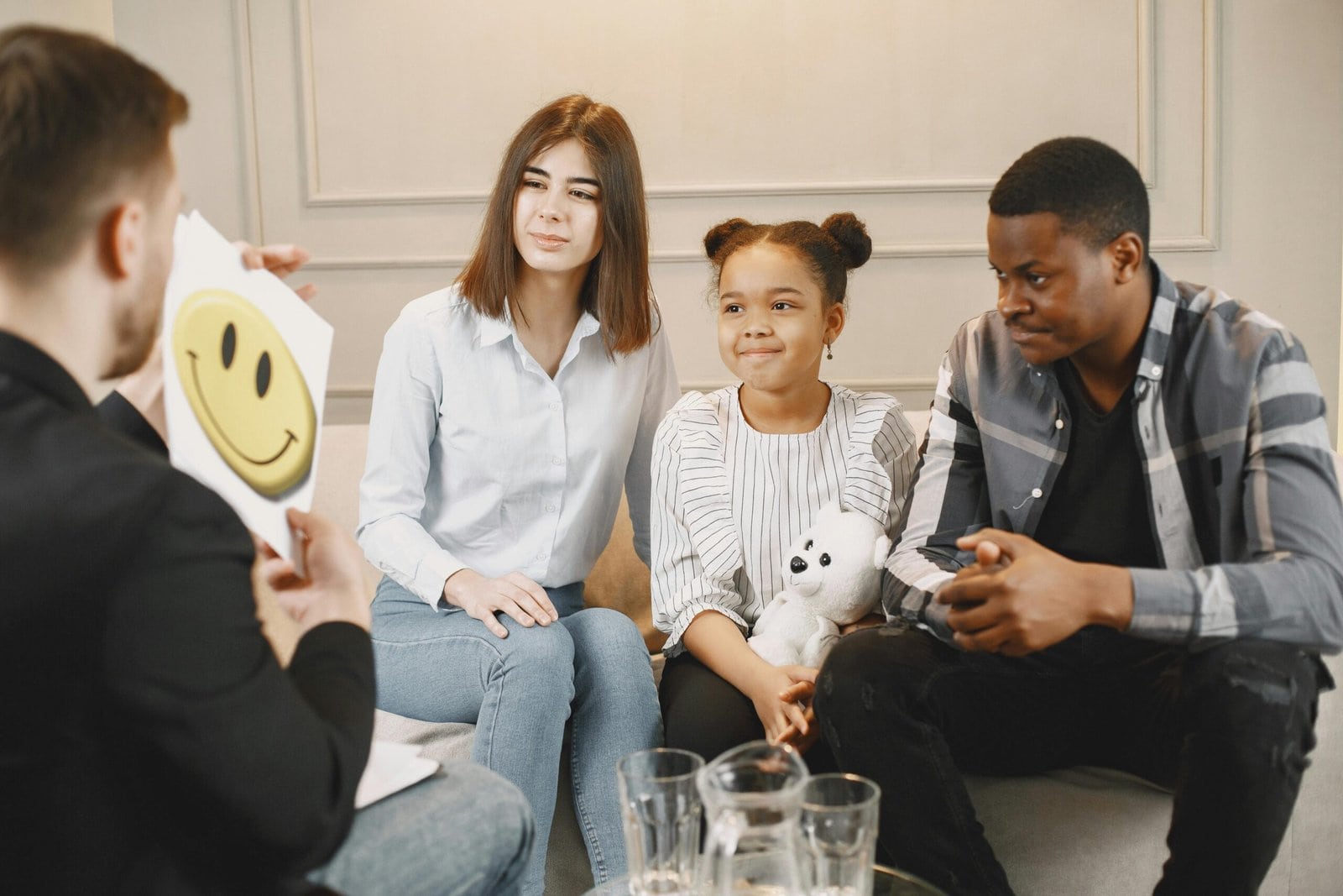 two adults and one child sitting