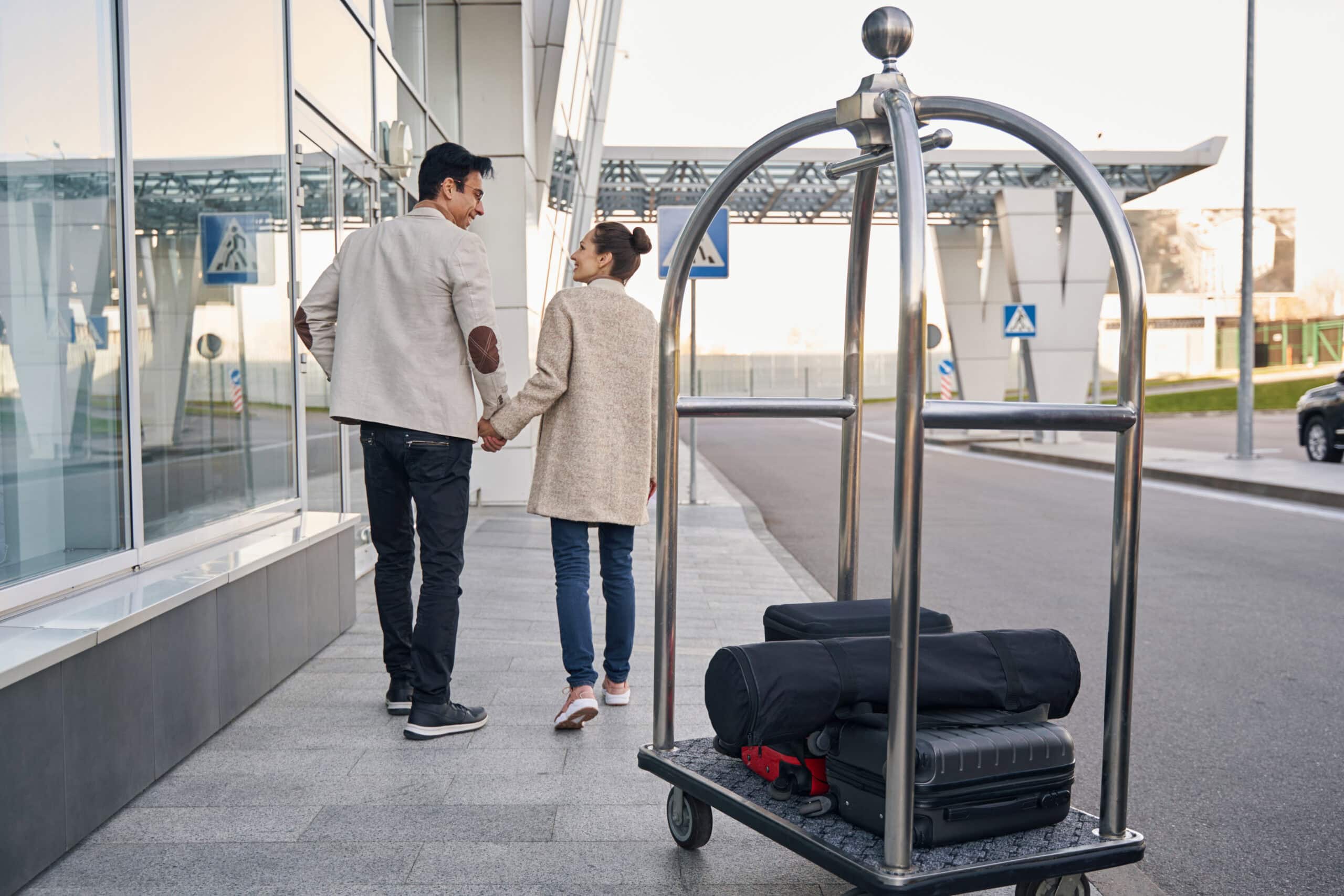 couple in love going together along airport buildi 2026 01 08 06 50 44 utc scaled