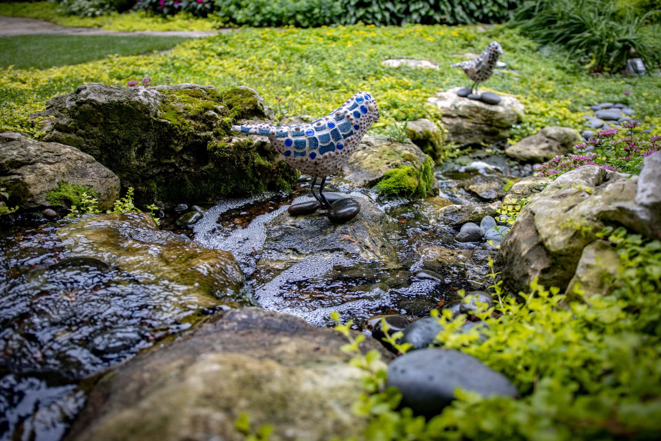 bird statue by water