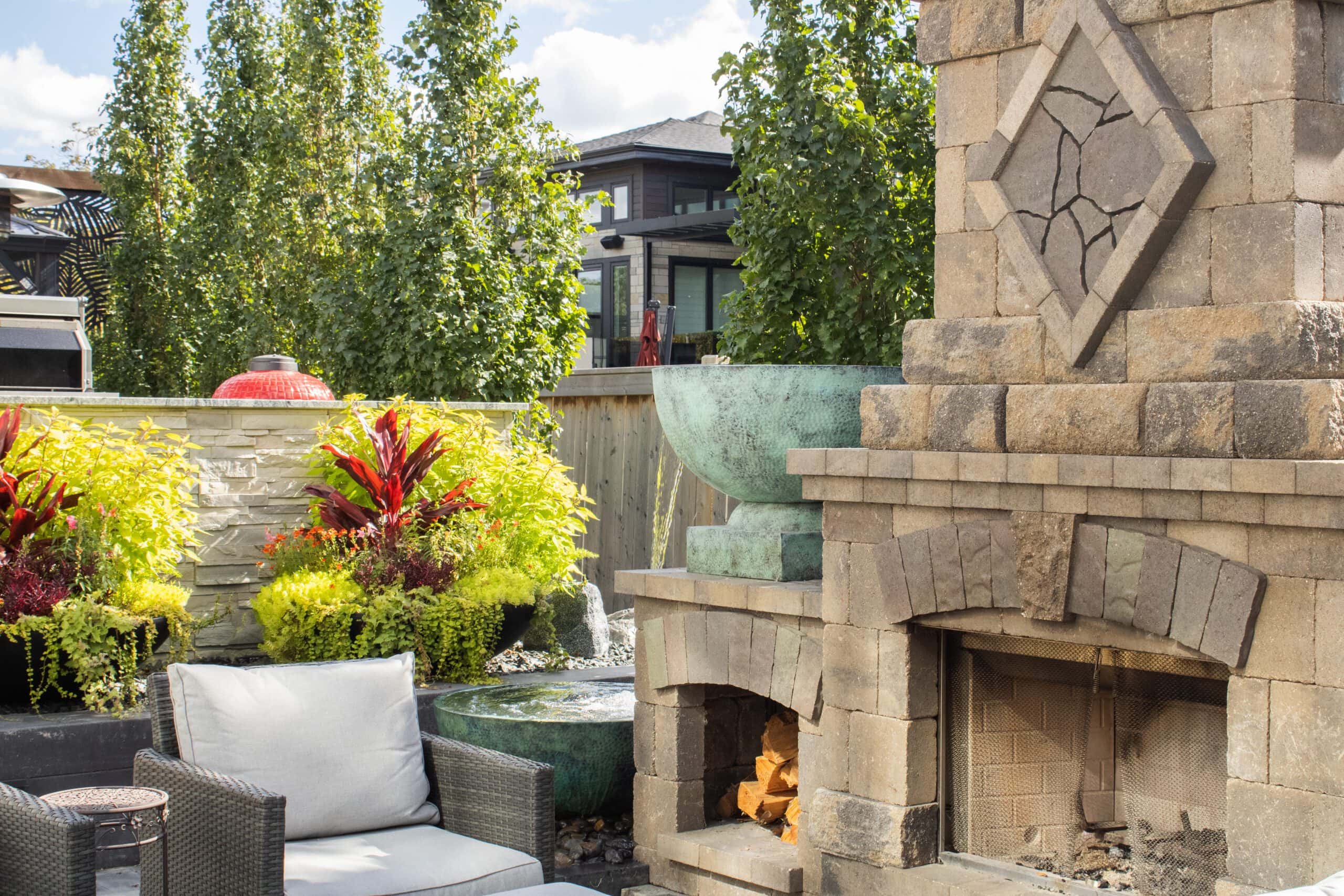 Winnipeg backyard landscaping with custom stone fireplace at Tuxedo Terrace