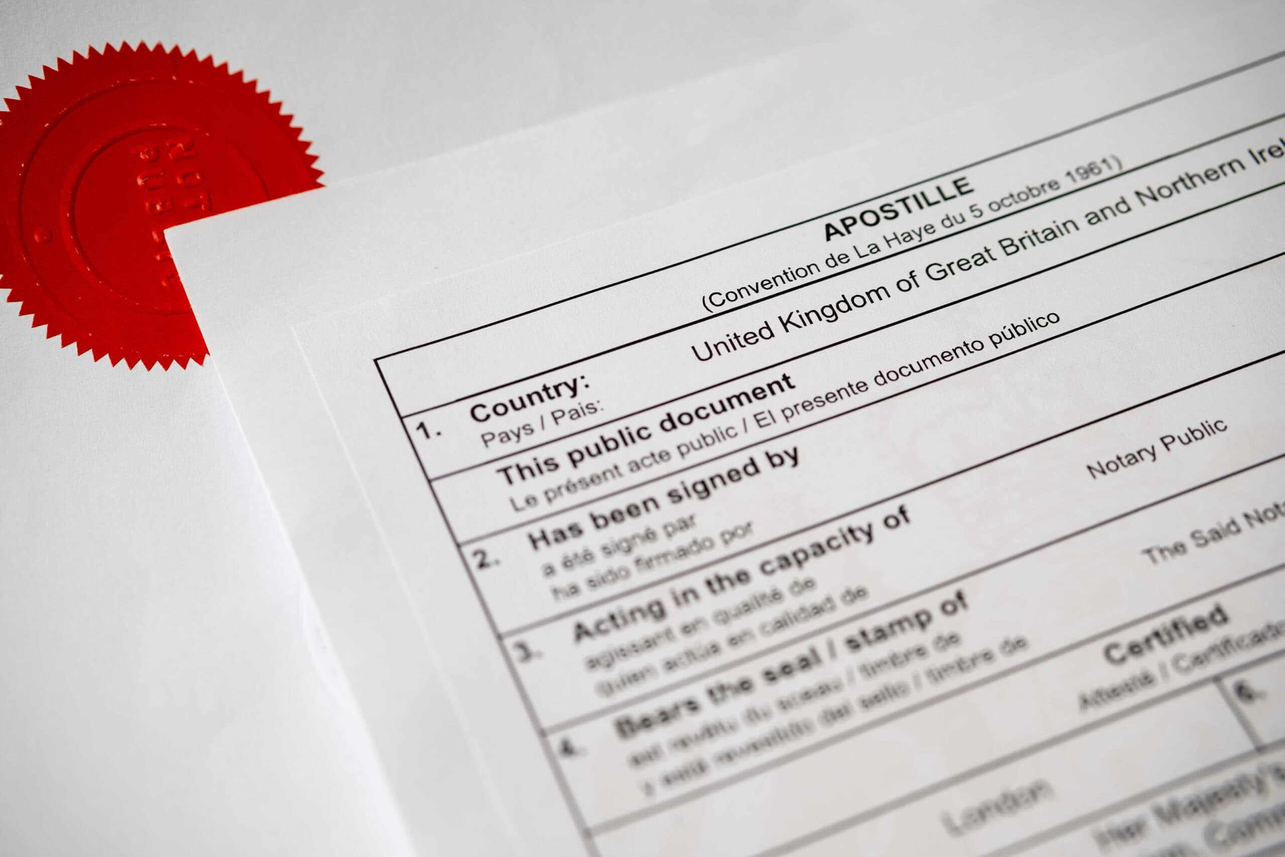 Authentic Apostille certificate document. The red stamp "NOTARY PUBLIC" on official document seen on the blurred background. Real documents. - La Jolla Mobile Notary Apostille Authentication