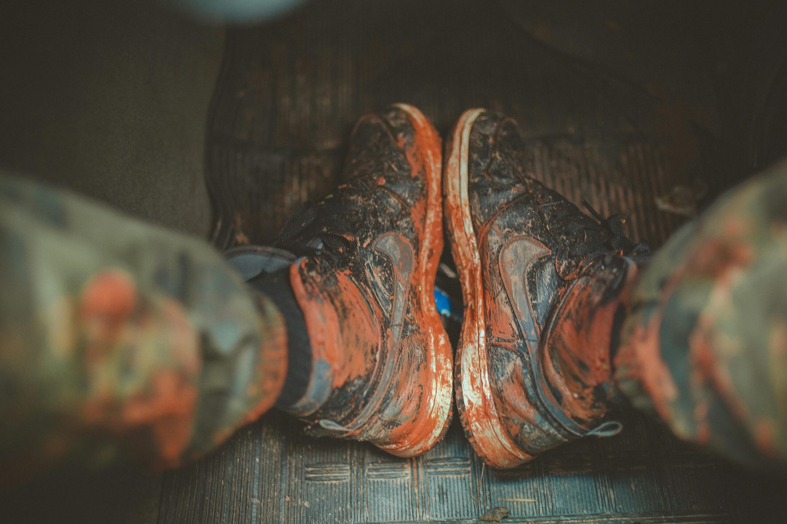 Close-up of muddy boots inside a vehicle, capturing the essence of adventure and rugged outdoor lifestyle.