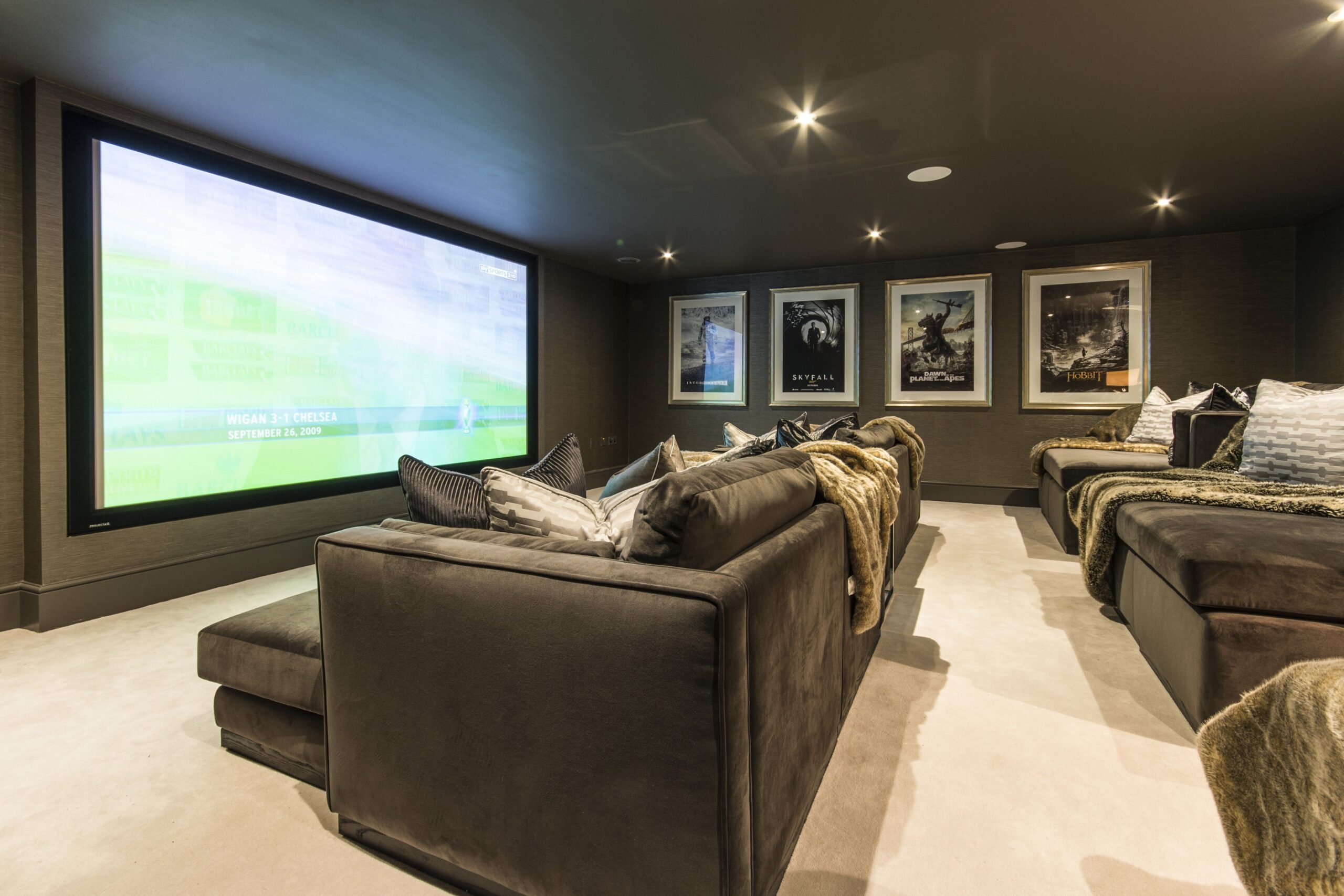 Small home cinema room installation in Surrey with surround sound and recliner seating