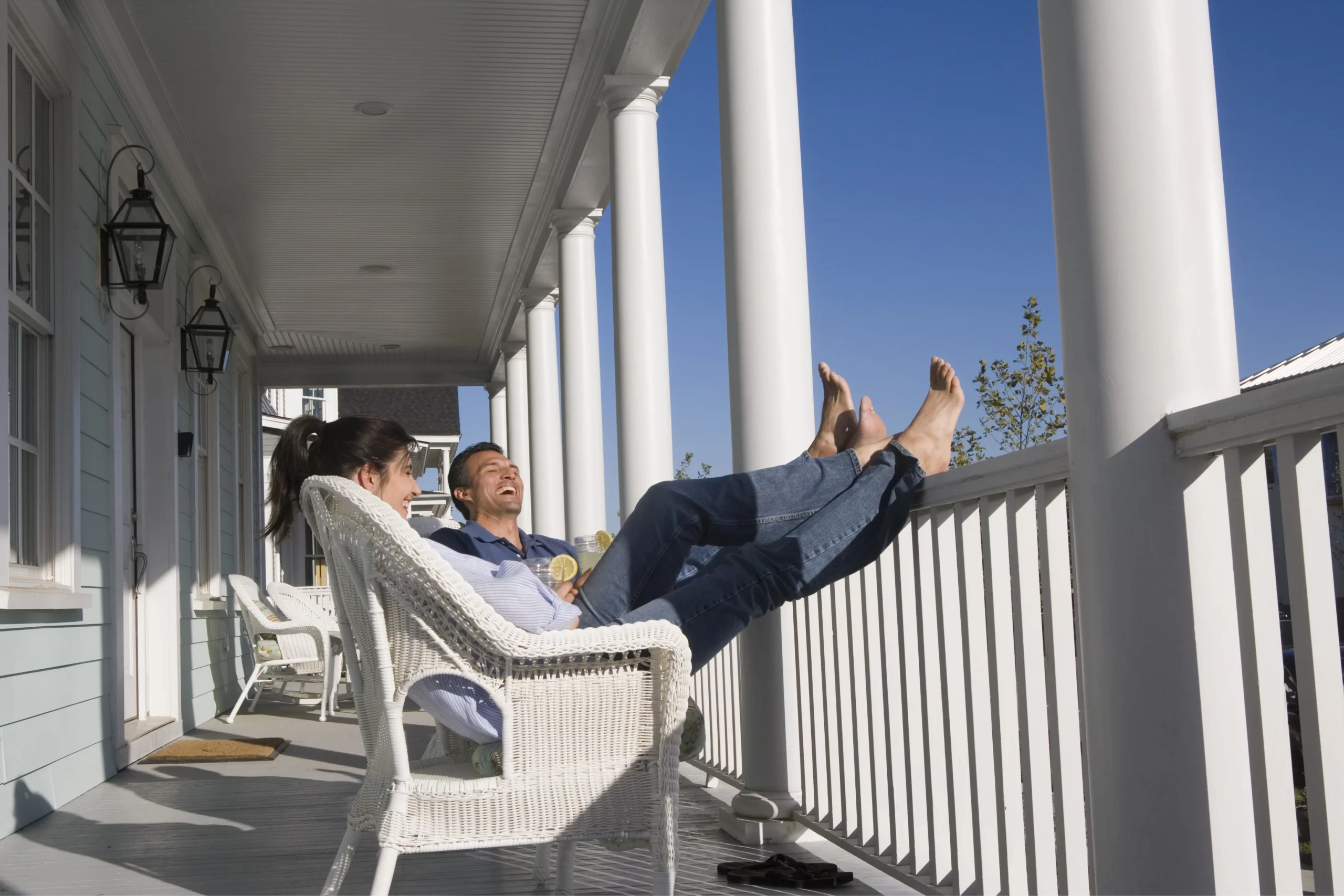 couple sitting on porch of bed and breakfast