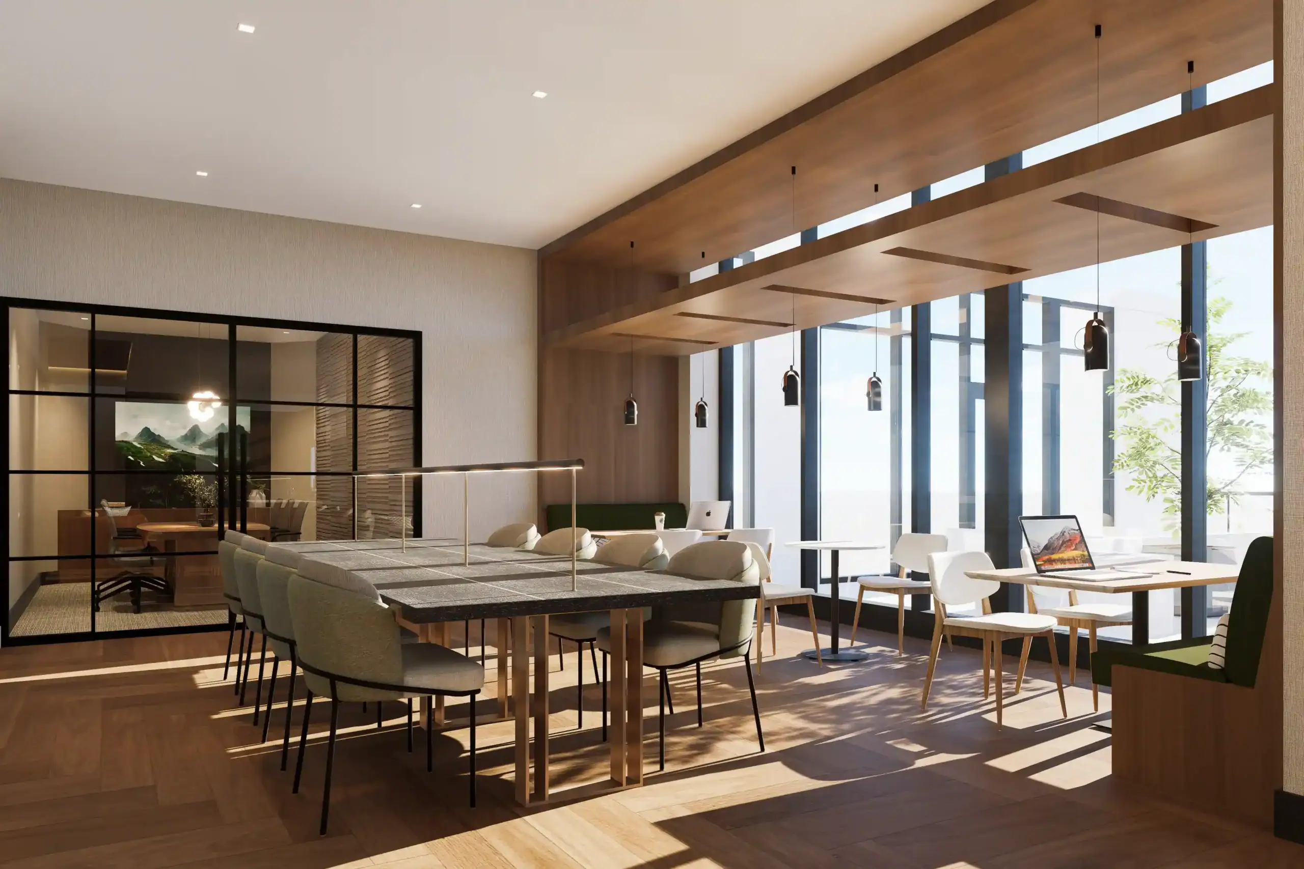Modern coworking lounge with collaborative worktables, café seating, and private glass meeting room.
