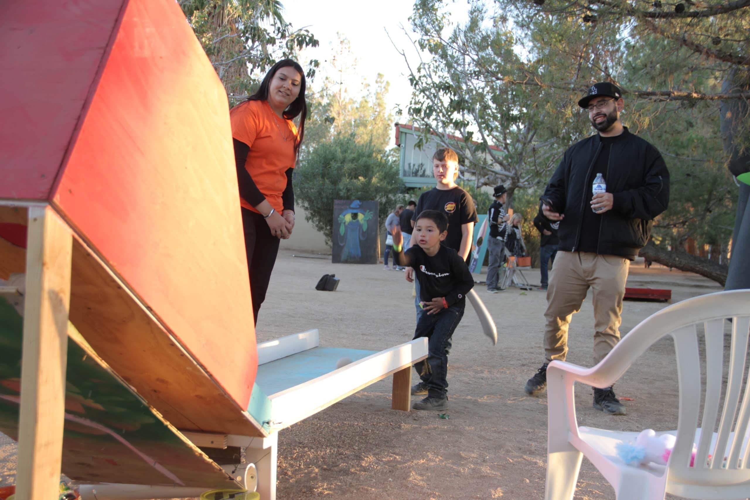 A family enjoys at carnival game at the Lone Wolf Colony Fall Festival October 29, 2022.
