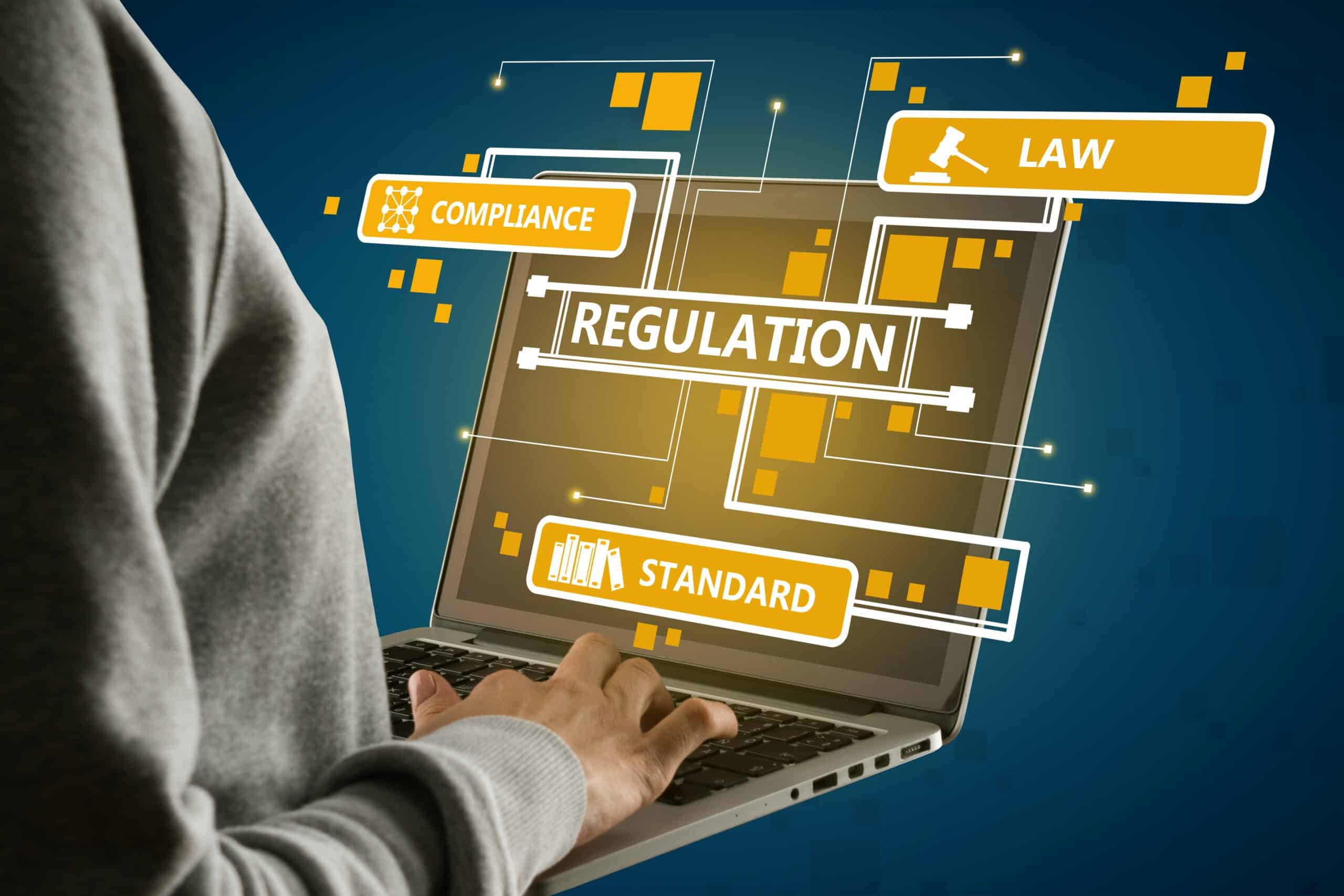 Regulations, law, compliance, and standards shown on a laptop screen.