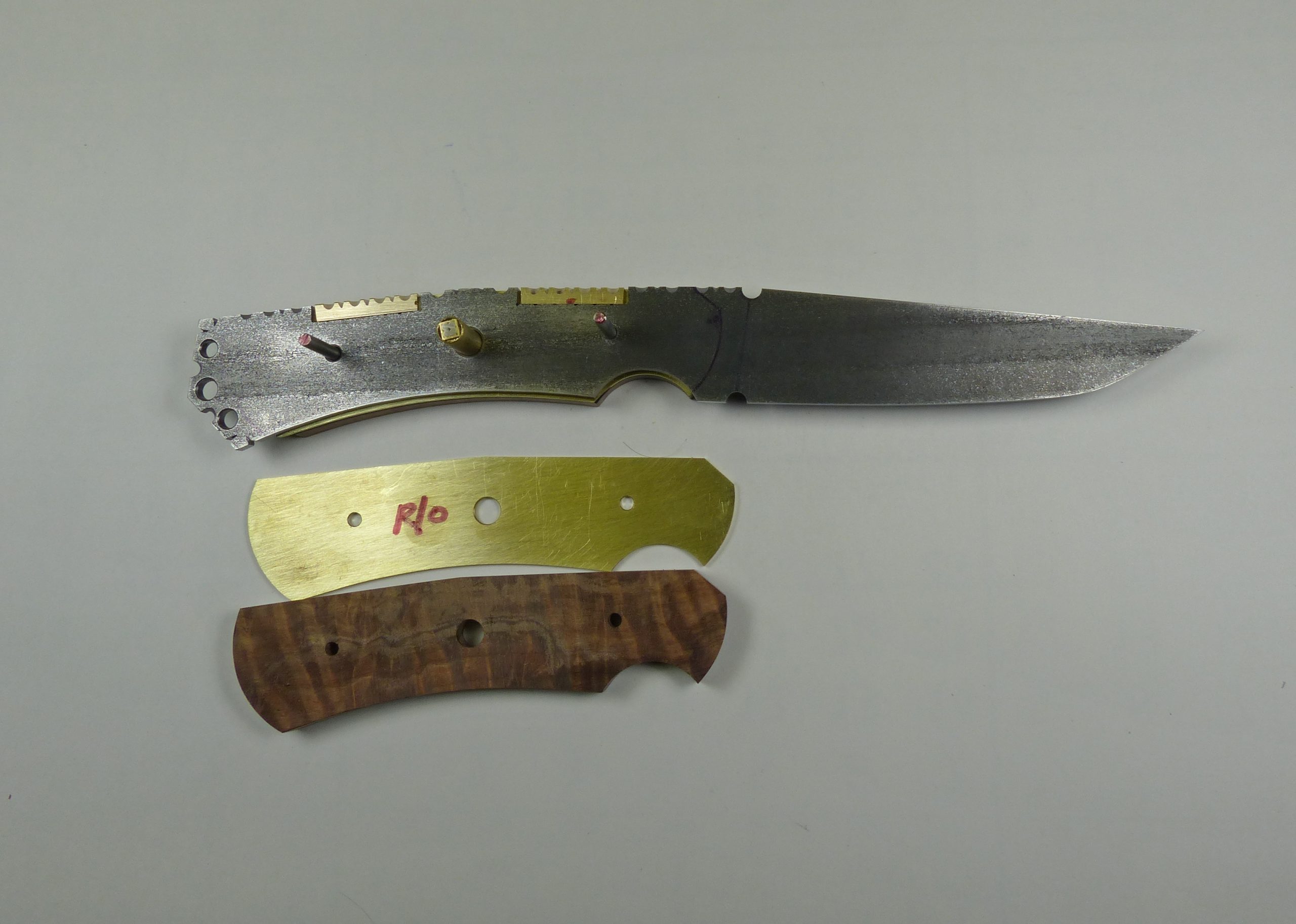 7 Knife blade with brass and wood handle pieces Knife blade with brass and wood handle pieces