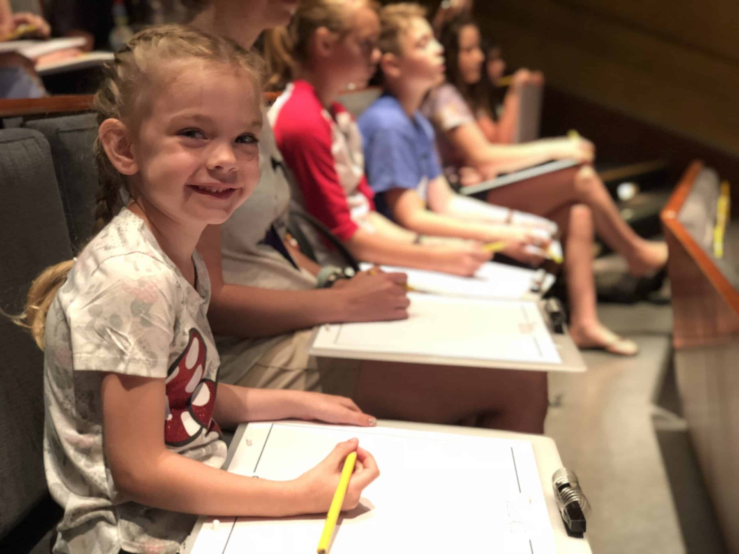 Bright young girl smiling during a children's educational program or summer camp in Orlando, Florida.