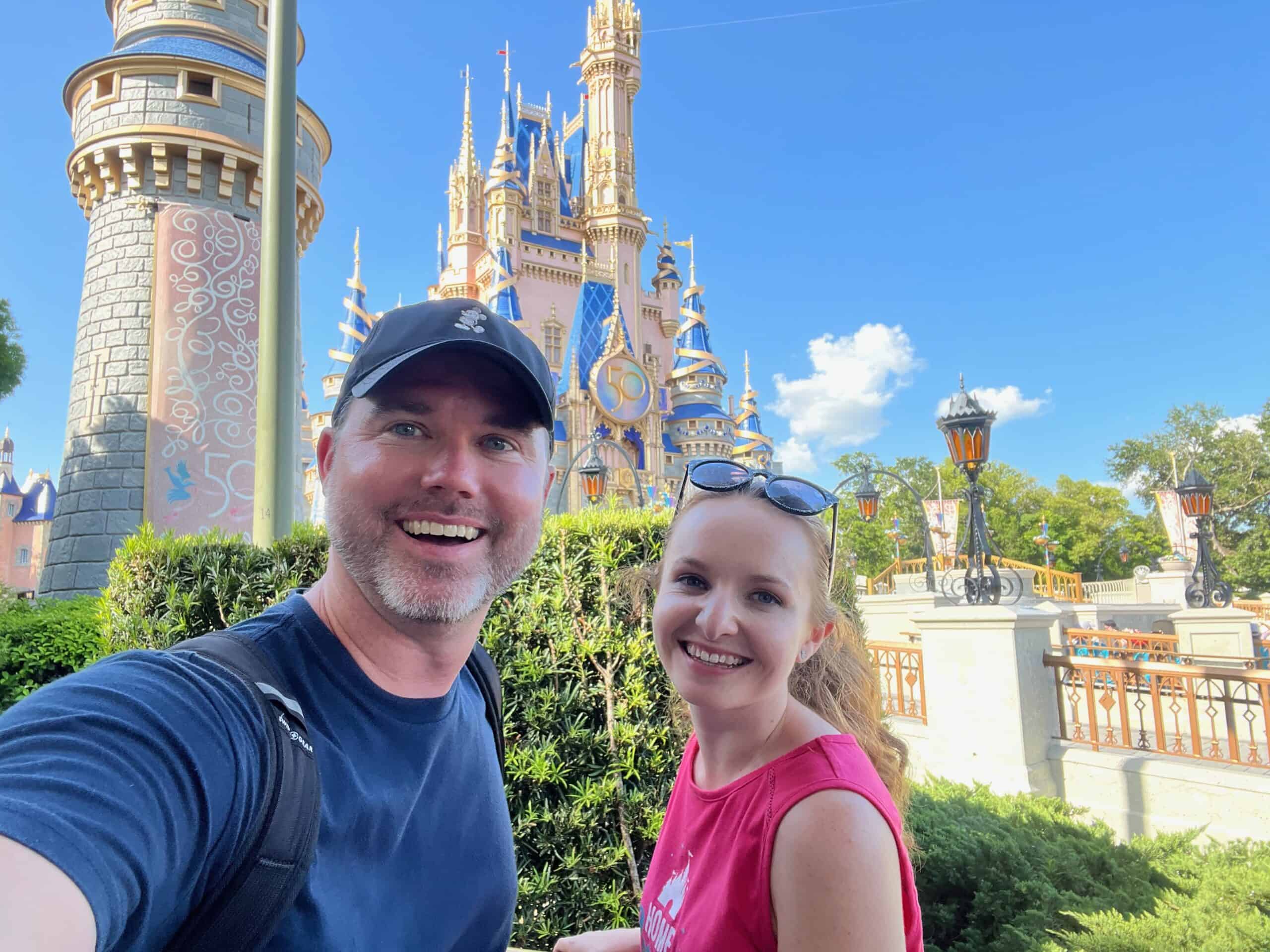 Youthful couple enjoying a magical day at Disney's Sleeping Beauty Castle, part of a memorable Orlando vacation experience.