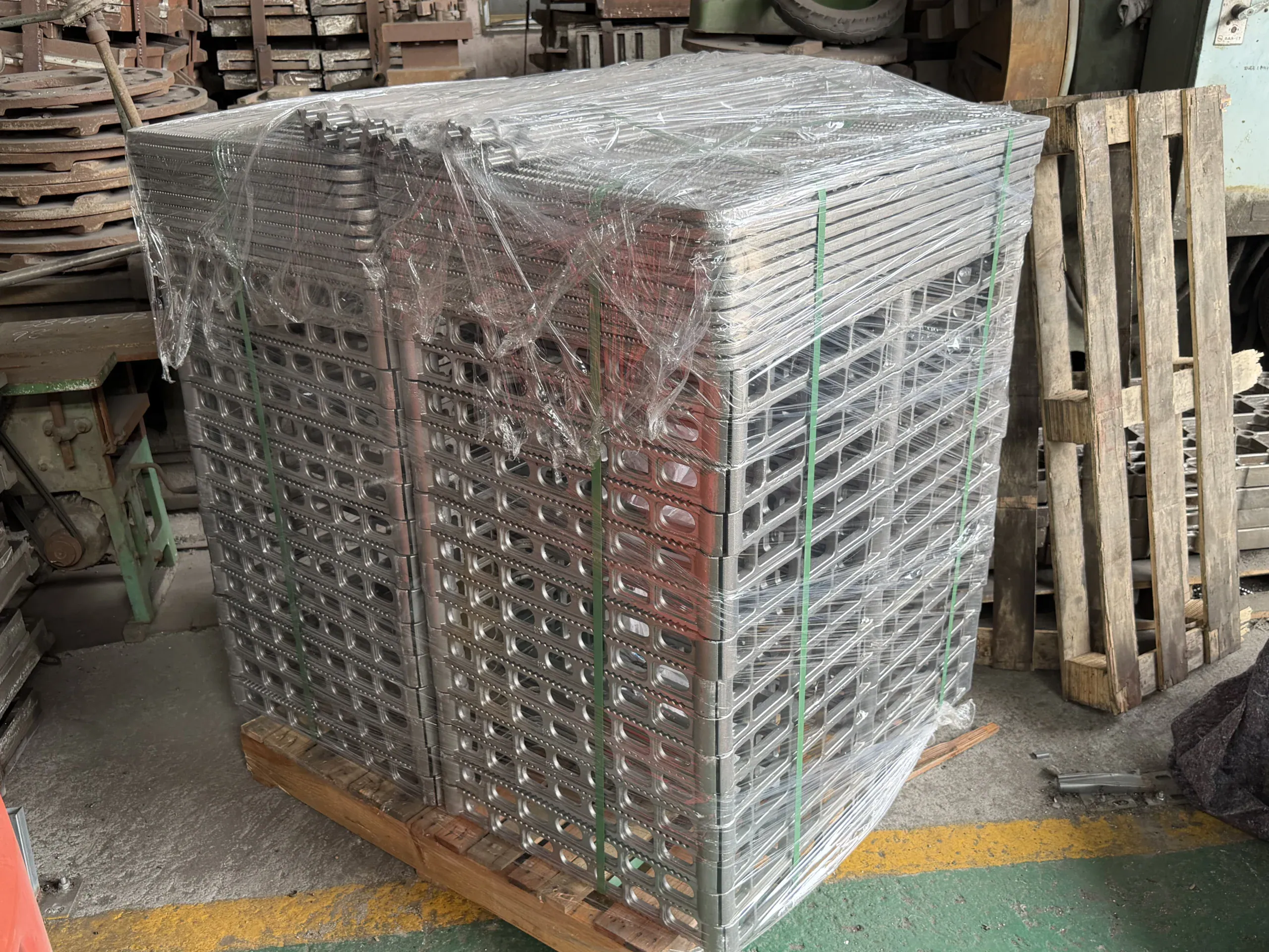 Stacked furnace components secured with protective wrapping on a pallet in the factory