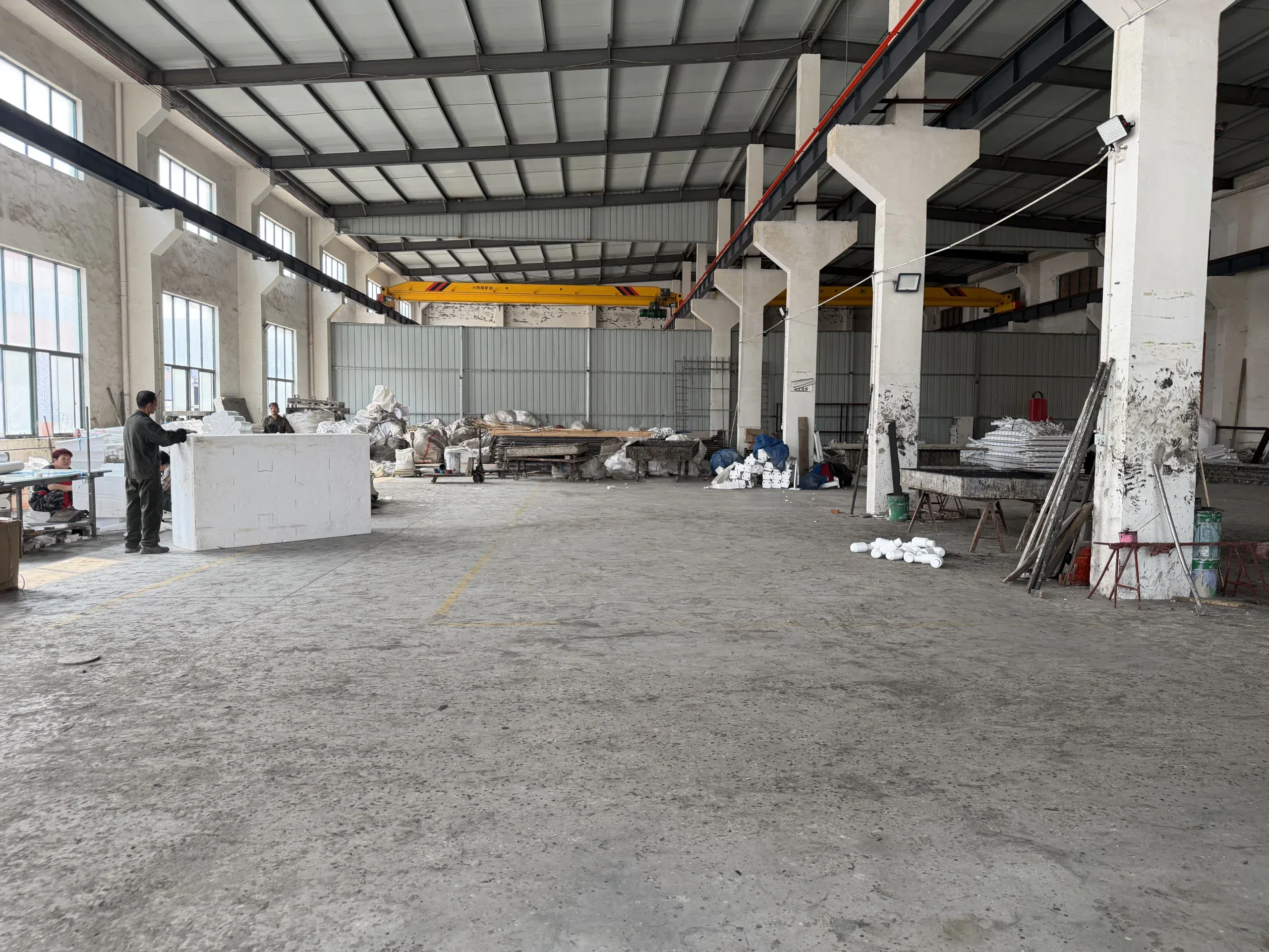 Interior of the manufacturing workshop with an overhead crane and open production floor