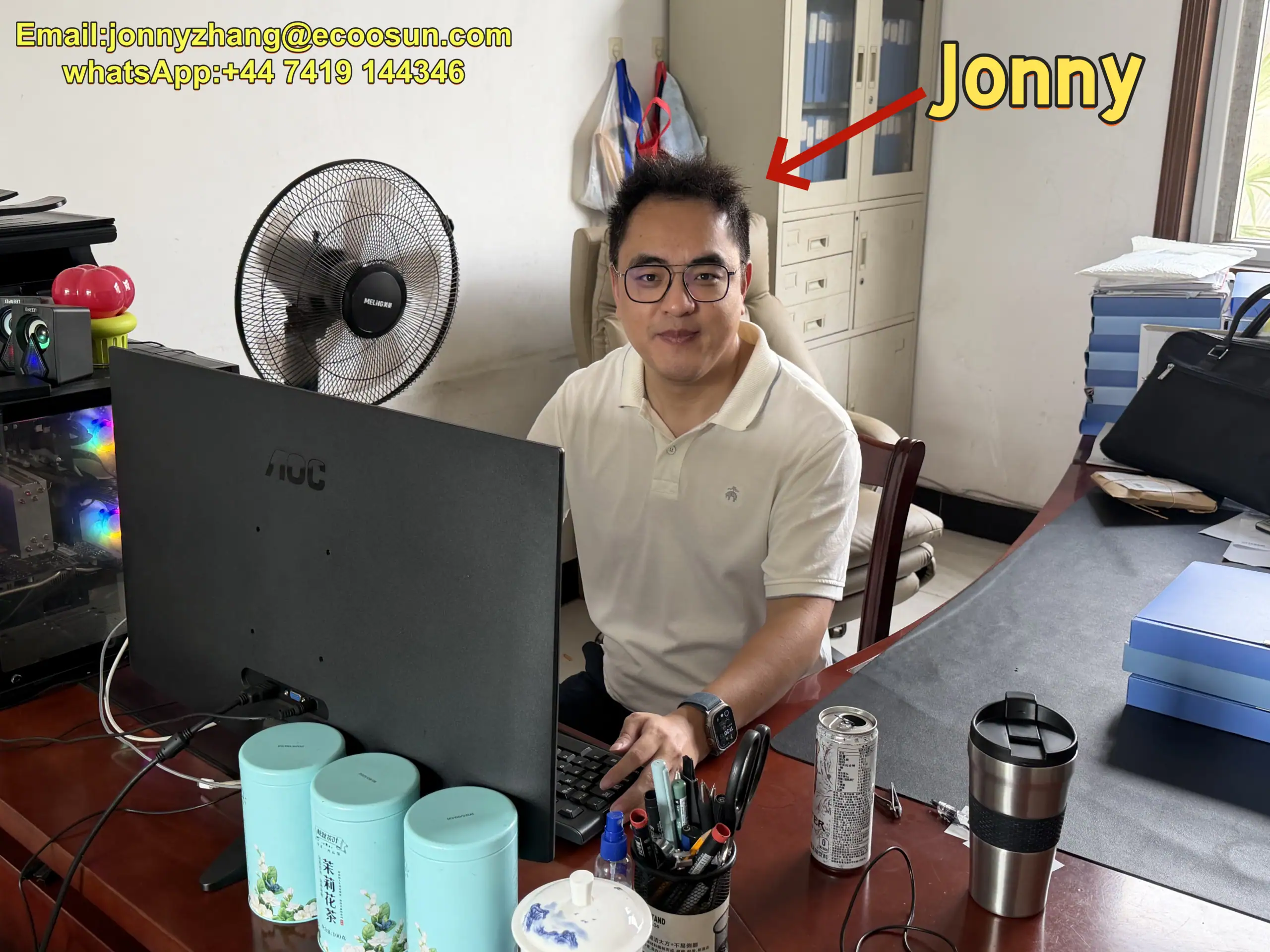 Person seated at a computer workstation in the factory office