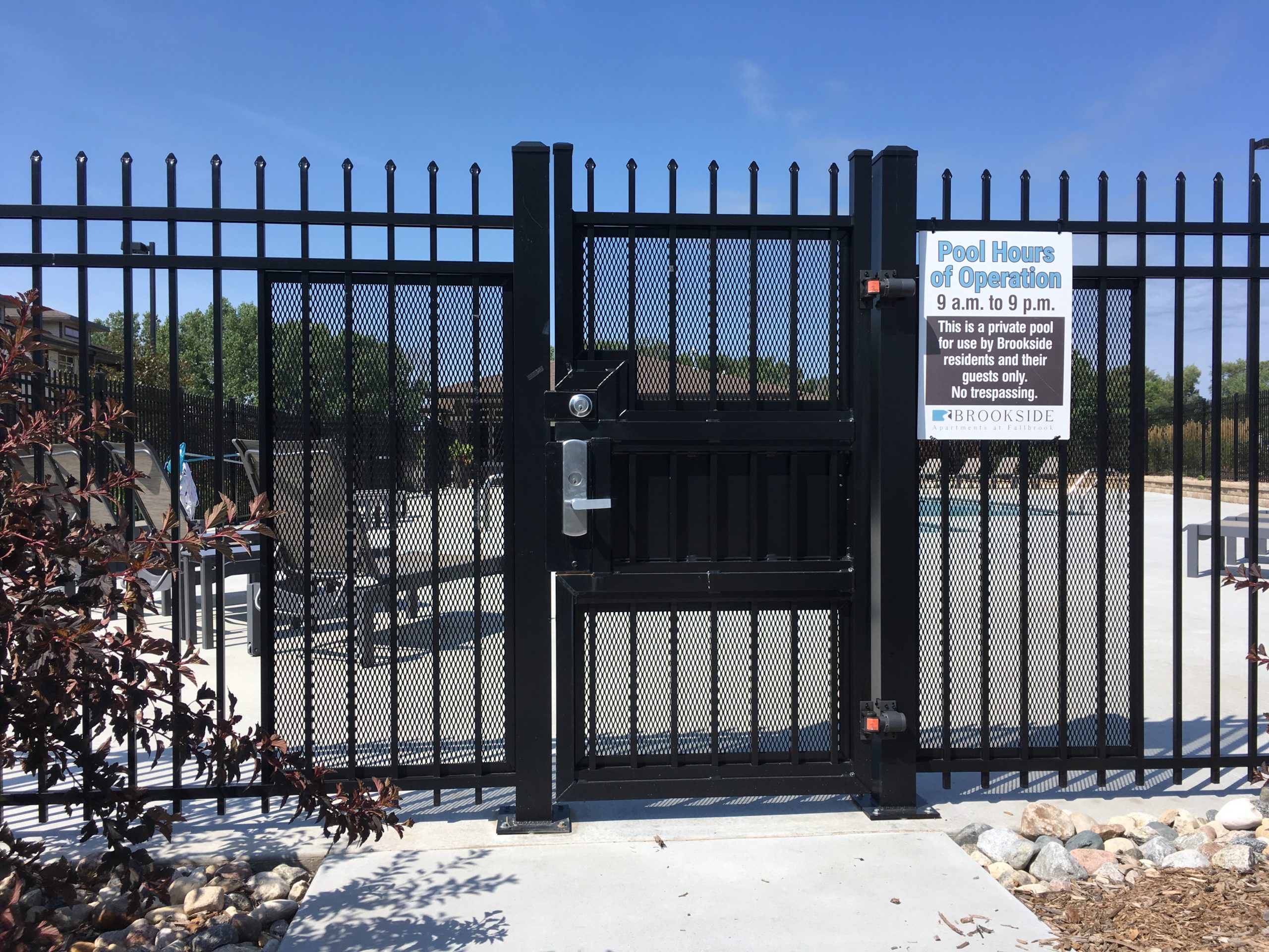 A black pedestrian entrance gate at Omaha's Brookside Pool.