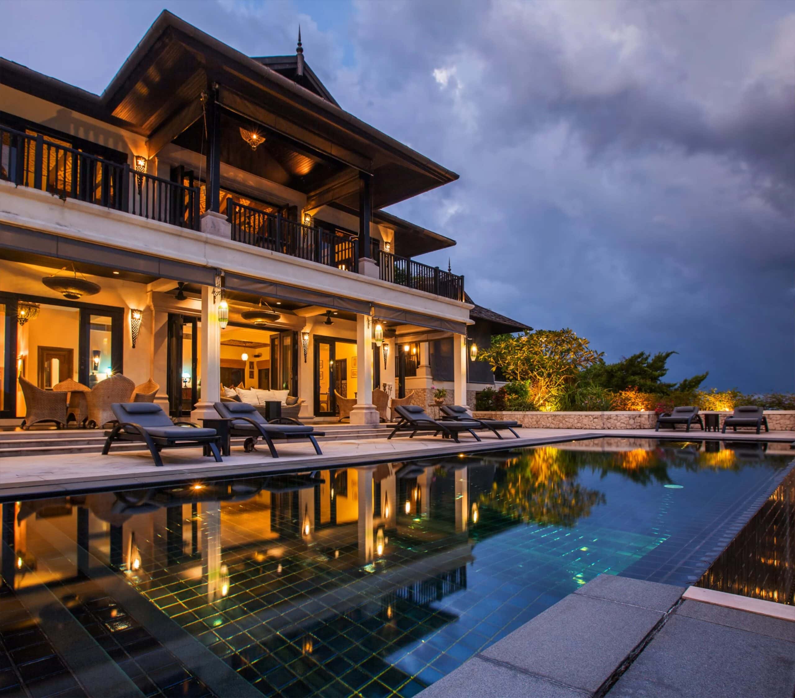 Exterior of a luxury hotel at dusk with striking hospitality design that includes a resort style pool