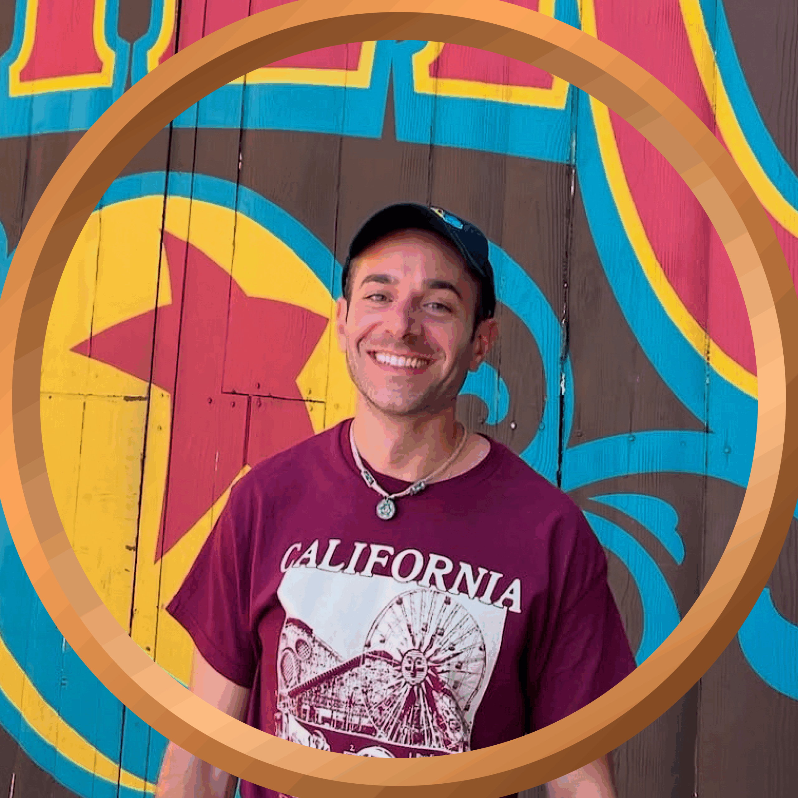 Vibrant colorful mural with smiling young man in California-themed t-shirt at 407 and Beyond Vacation Co.