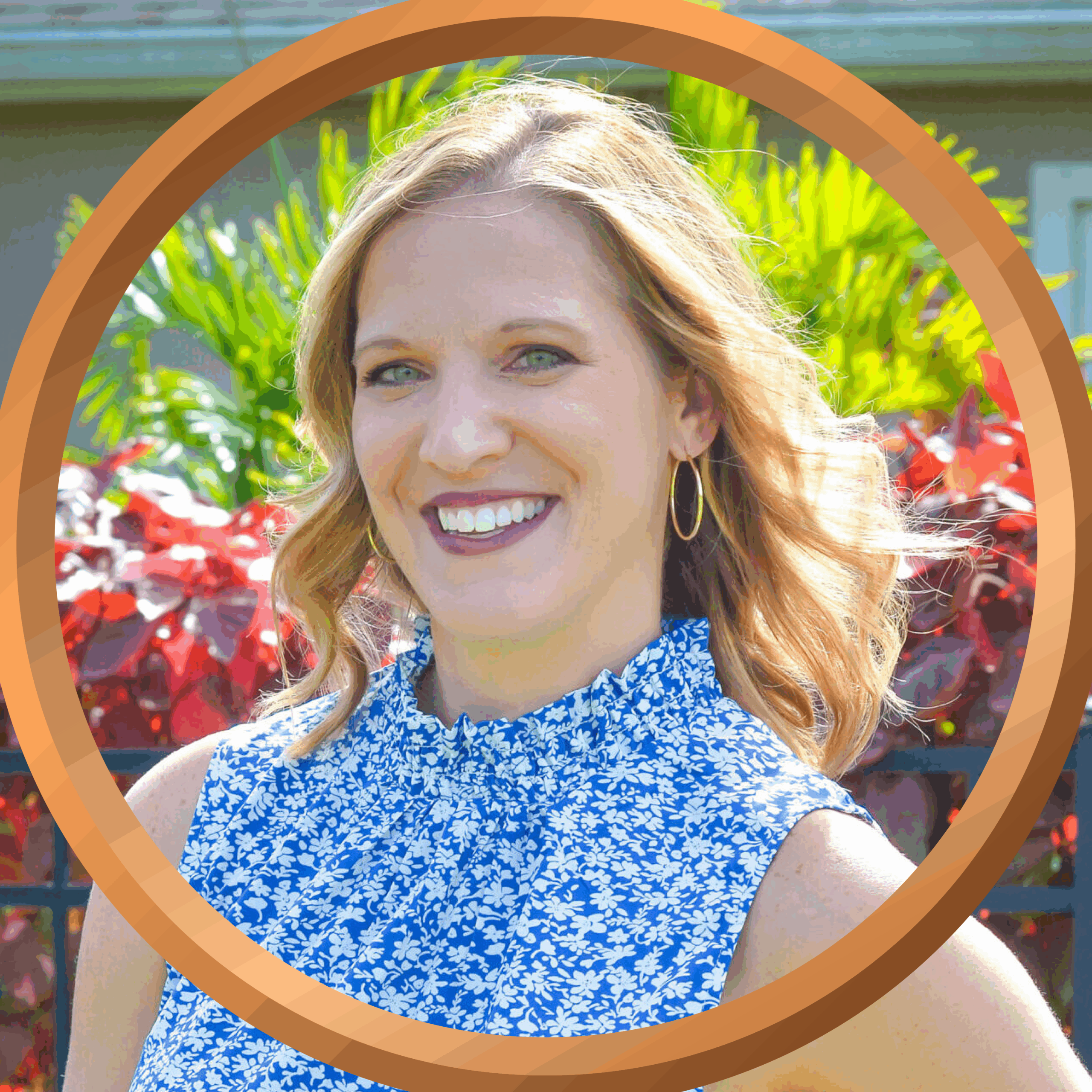 Woman smiling in a blue floral top with tropical plants background, vacation, travel, Florida, Sunshine State.