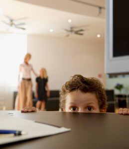 A frightened child looks over the counter - fear of CPS or CHFS concept