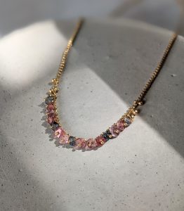 Pastel spinel and gold vermeil necklace on a grey background
