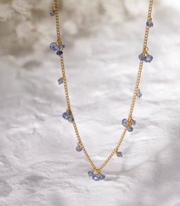 Sapphire beaded necklace in gold vermeil on a dappled background