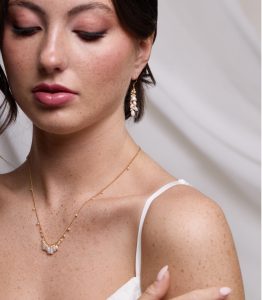 baroque pearl blossom earrings and necklace on a model